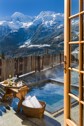 A hot tub wit a fantastic view of snow-covered alps.